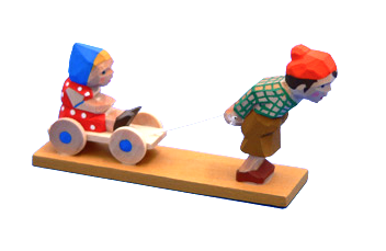 Young Boy pulling a Little Girl on a Wagon