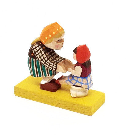 Mother with Child Sitting on Pot